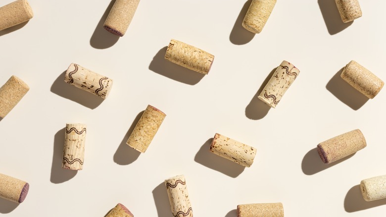 Many wine corks on white background