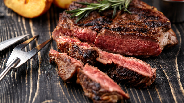 sliced steak and utensils