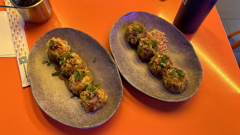 Two plates of thai dumplings