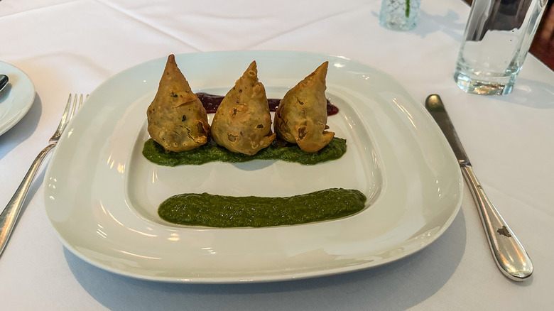 three samosas on a plate