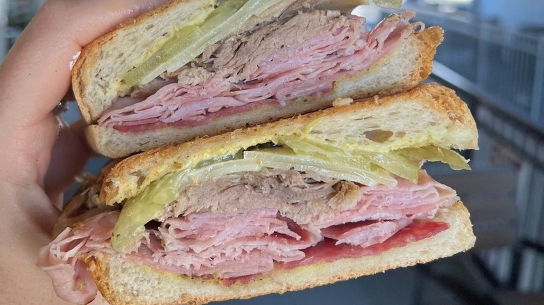 Hand holding Cuban sandwich