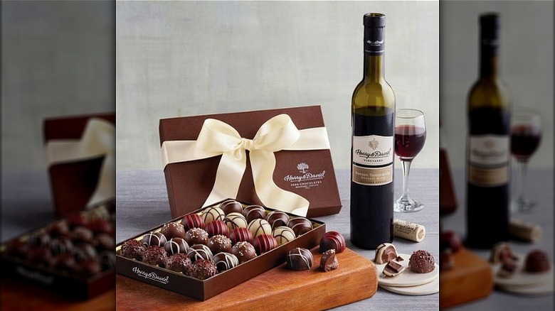 a gift box of harry & david chocolate truffles with a bottle of red wine