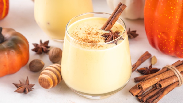 Eggnog with a cinnamon stick and star anise