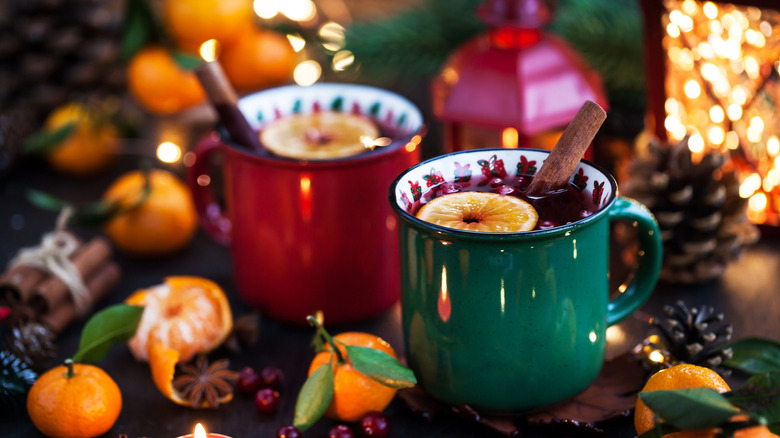 Two mugs of spiced wine on a holiday table