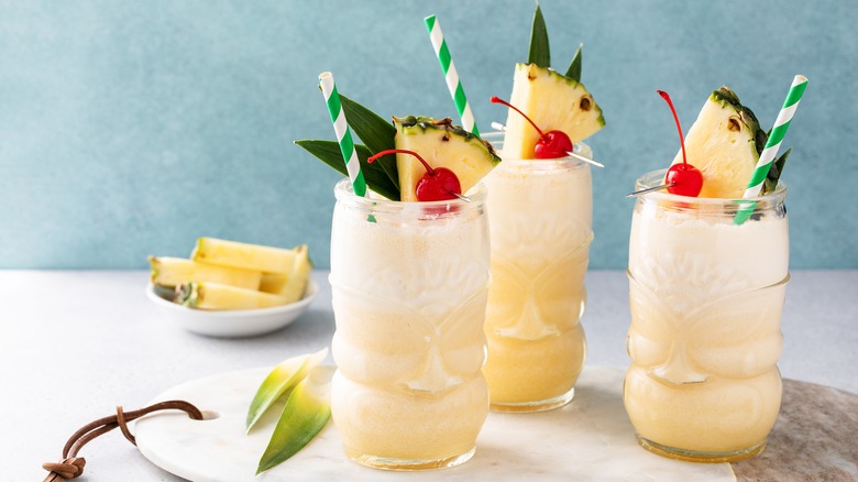 Three piña colada cocktails