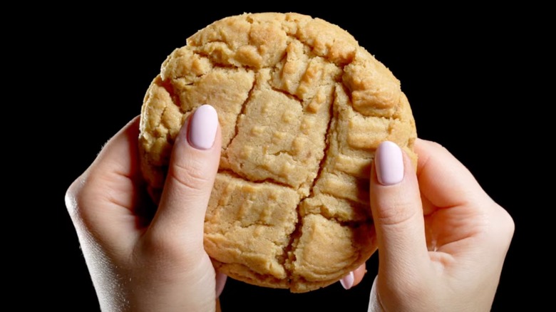 handheld Crumbl peanut butter cookie