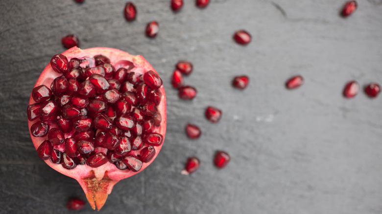 Pomegranate with scattered seeds