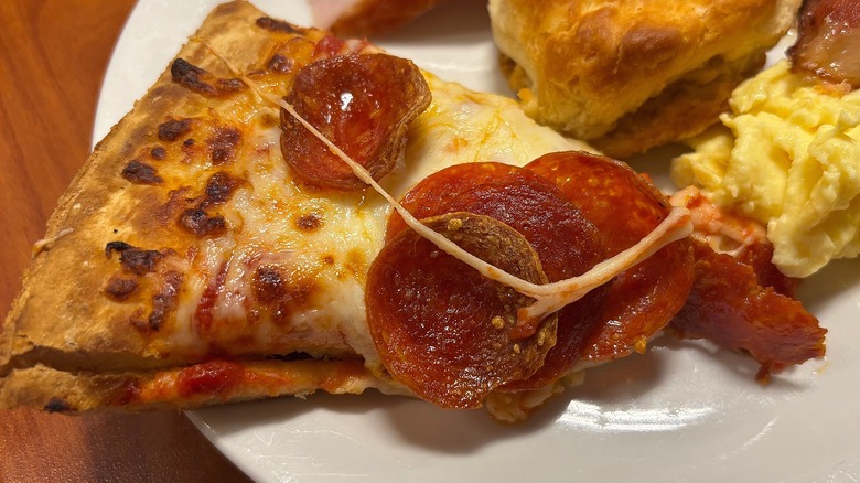 Slice of Golden Corral pepperoni pizza on white plate