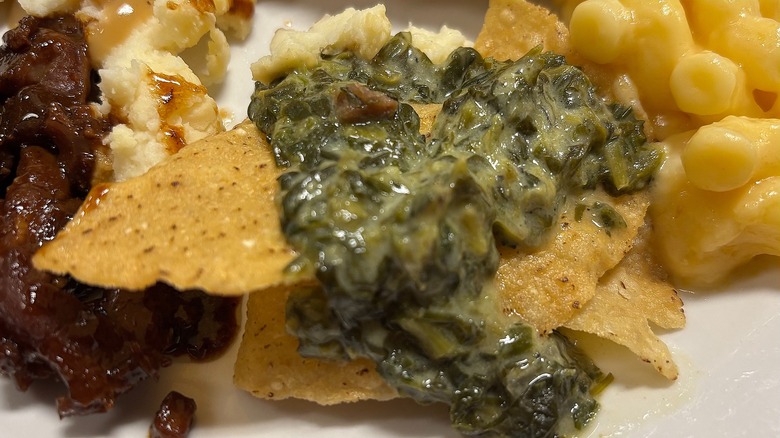 Golden Corral chips and creamed spinach on white plate