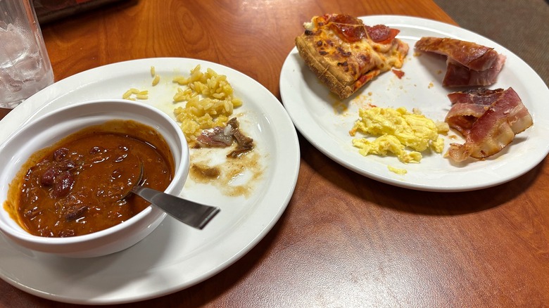 Two empty Golden Corral plates on wood table