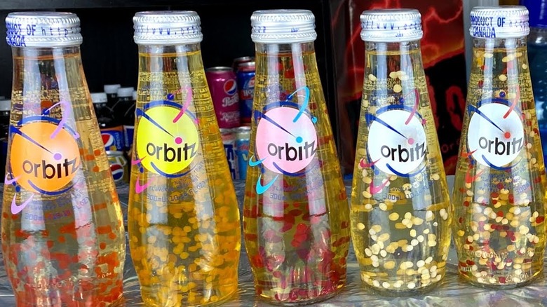 Bottles of Orbitz soda in row