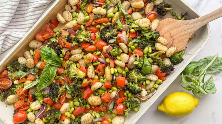 Mixed Veggie Sheet Pan Gnocchi with wooden spoon on countertop