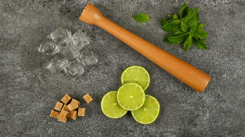 Cocktail ingredients and muddler