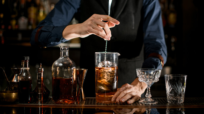 bartender stirring a cocktail