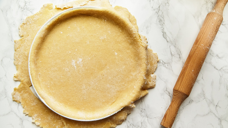 Rolling pastry over dish