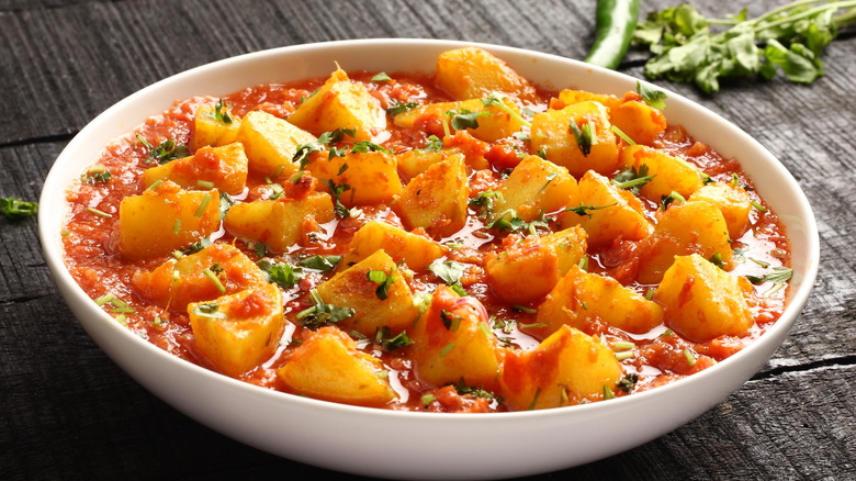 Potato curry in white bowl