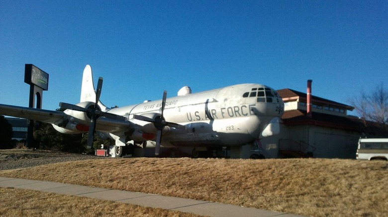 Grounded airplane and restaurant sign