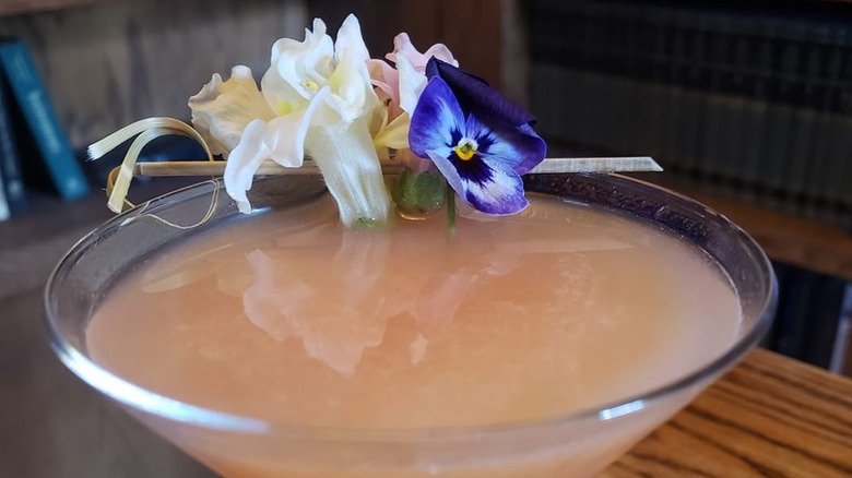 Edible flowers on peach cocktail 