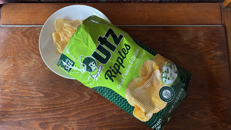 Open bag Sour Cream & Onion chips pouring into bowl