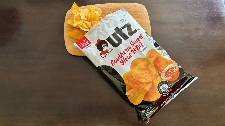 Open bag of Southern Sweet Heat BBQ chips spilling onto cutting board