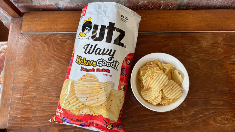 Bowl of Utz Heluva Good! French onion chips next to open bag on its side