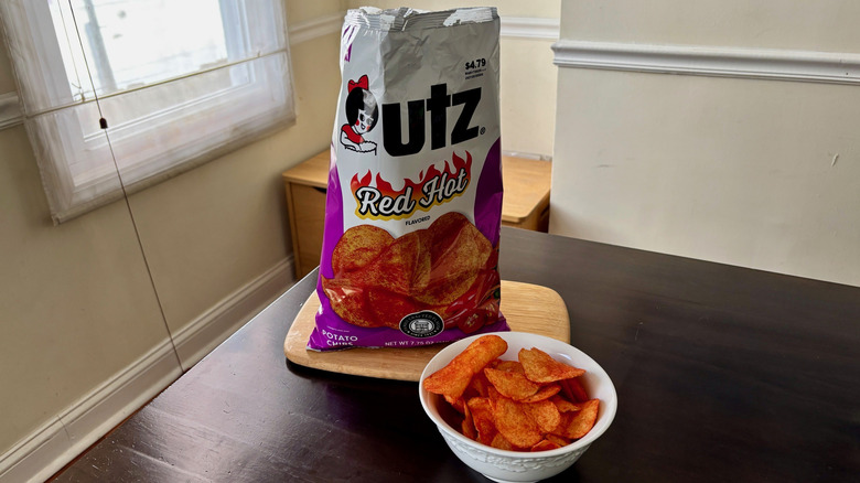 Bowl Red Hot chips next to open bag on table