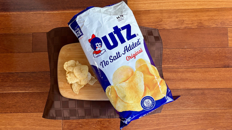 Open bag No Salt Added potato chip on cutting board