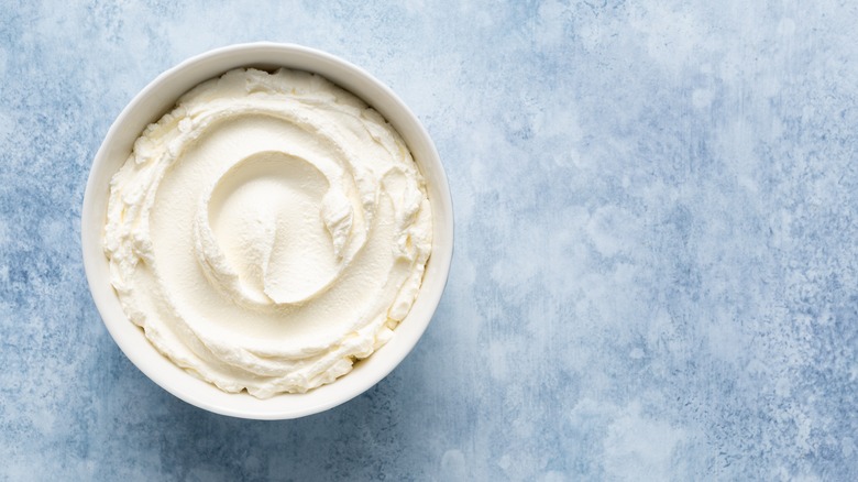 Ricotta in bowl with blue background