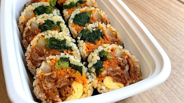 Kimbap in white takeout container