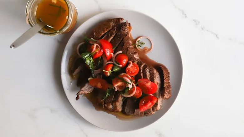 sliced steak with tomato vinaigrette