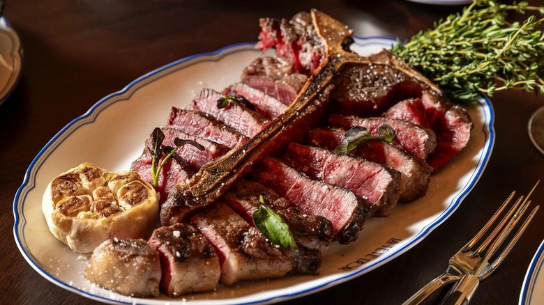 porterhouse steak on plate with garlic