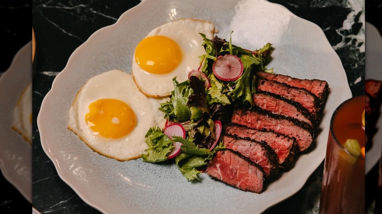 steak and eggs on plate