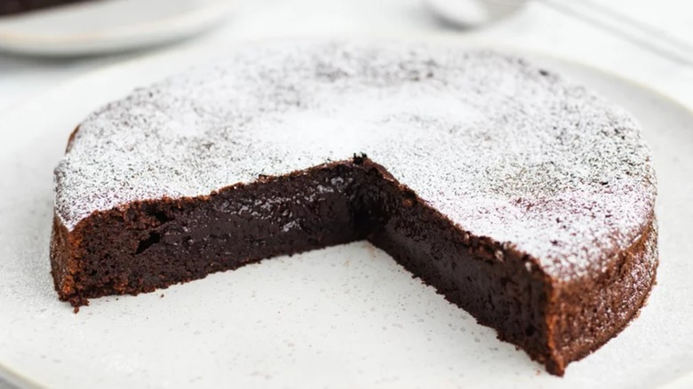 A cut flourless chocolate torte on a plate