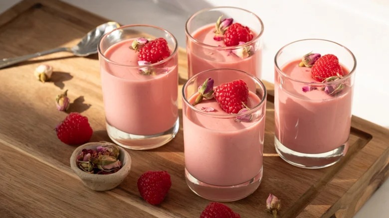 Four glass cups or raspberry rose posset