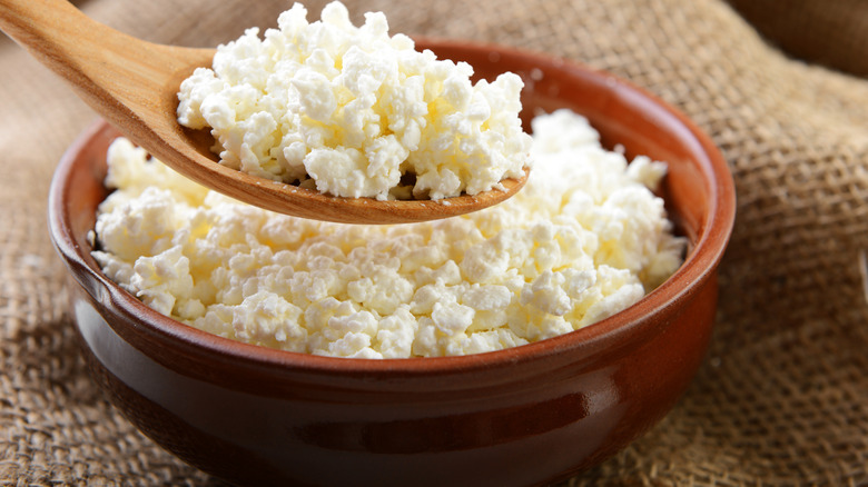 Cottage cheese in crock with spoon