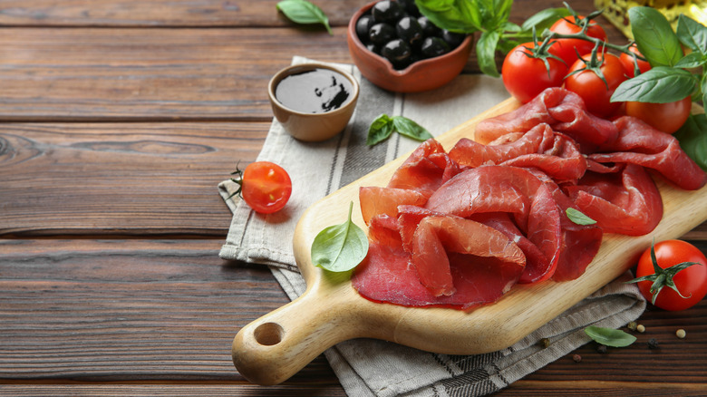 sliced bresaola on cutting board