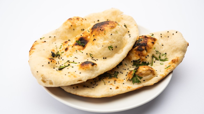 Two naan on a white plate