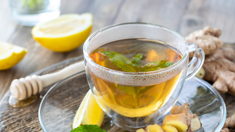 sliced ginger root and tea