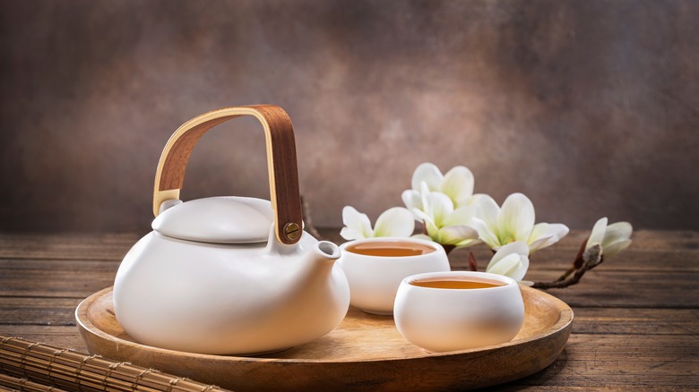 jasmine flowers next to tea pot