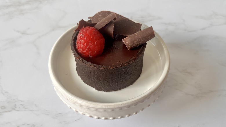 chocolate raspberry tart on stand