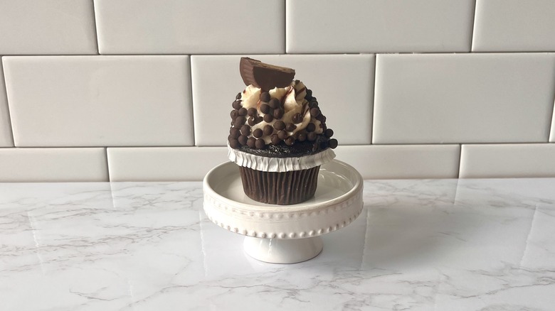 peanut butter cupcake on stand