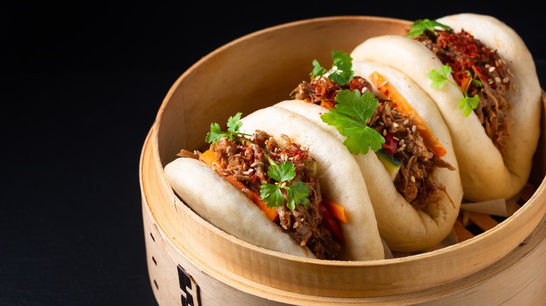 Three bao buns in steamer