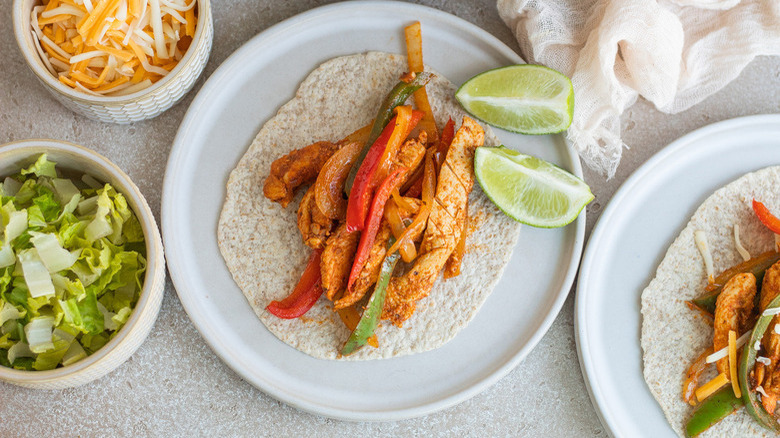 Chicken fajitas with lime wedges