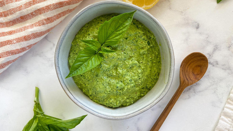 Bowl of homemade pesto with fresh basil