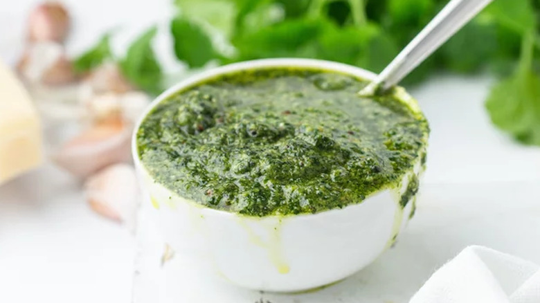 Very full small bowl of freshly made pesto with cilantro