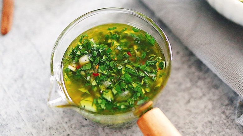 Small glass bowl of fresh chimichurri sauce