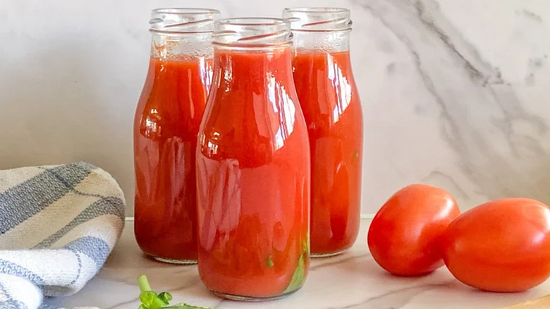 Three open jars of homemade tomato passata