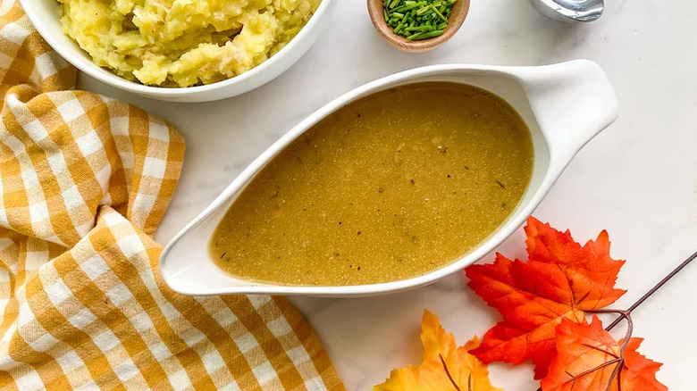 Jug of vegan gravy on work surface