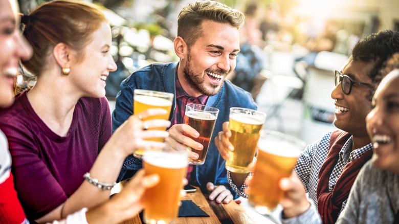 People holding glasses of craft beer