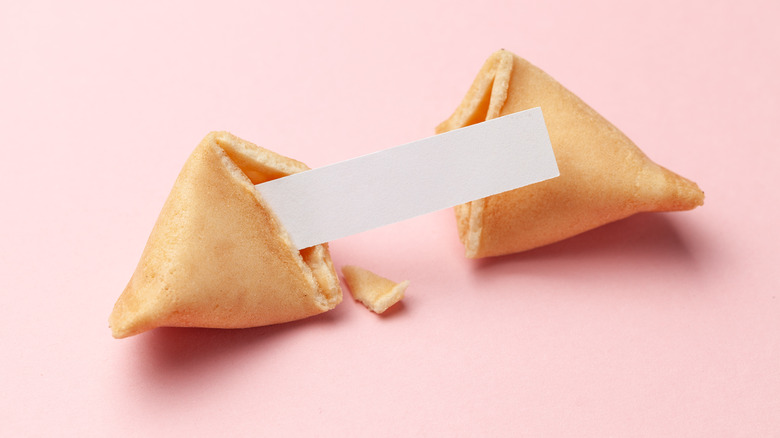 Fortune cookie on pink background